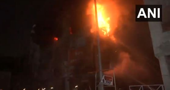 Image of firefighters working to control a fire at a uniform manufacturing shop and cafe near Neelam Mata mandir in Mayur Vihar Phase 2, Delhi.